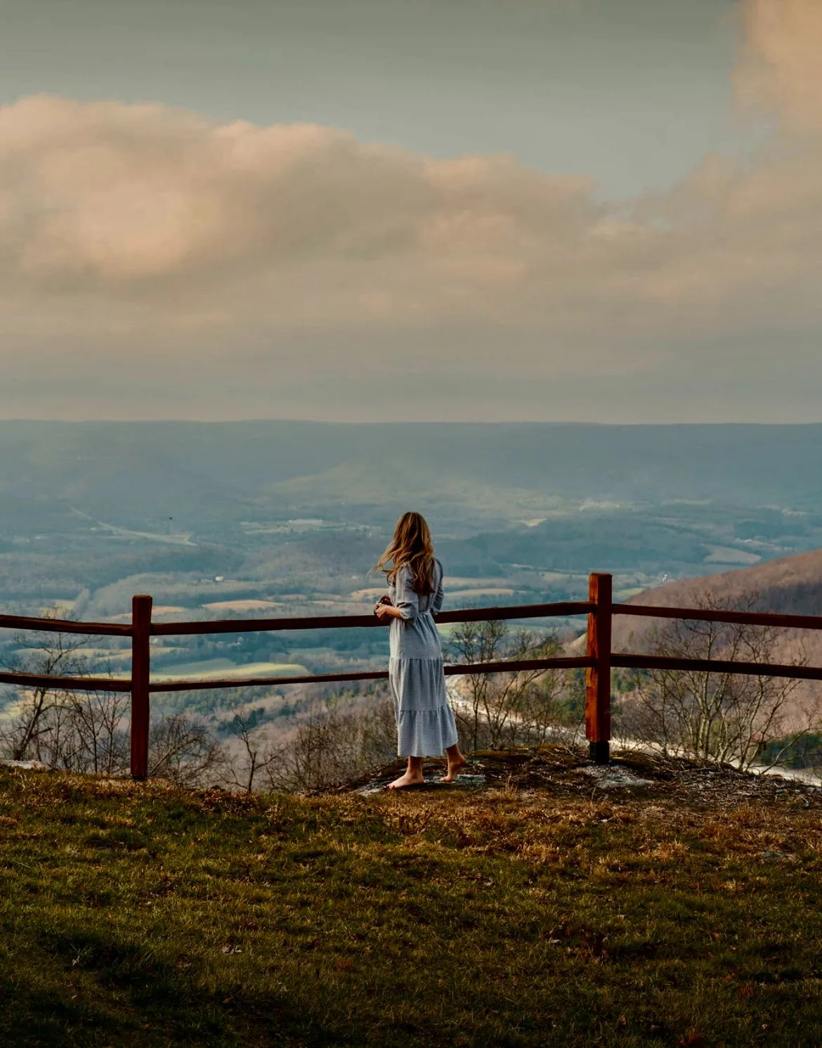 Woman standing at bluff railing overlooking Sequatchie Valley at The A-Frame Tennessee