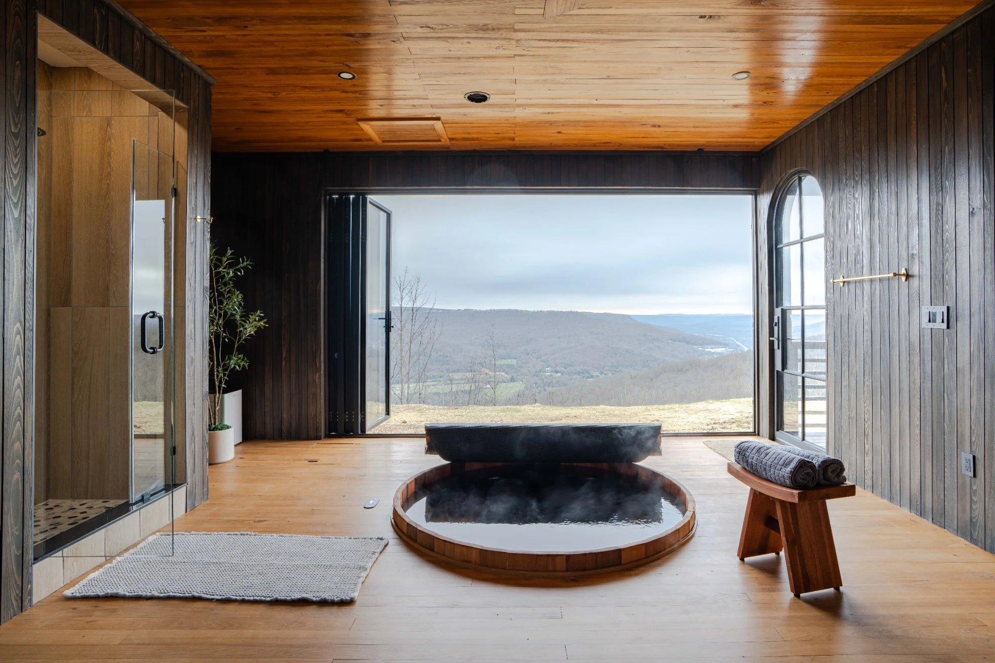 Japanese-inspired cedar soaking tub with panoramic valley view in the Wellness Room at Jackson Point, Sewanee