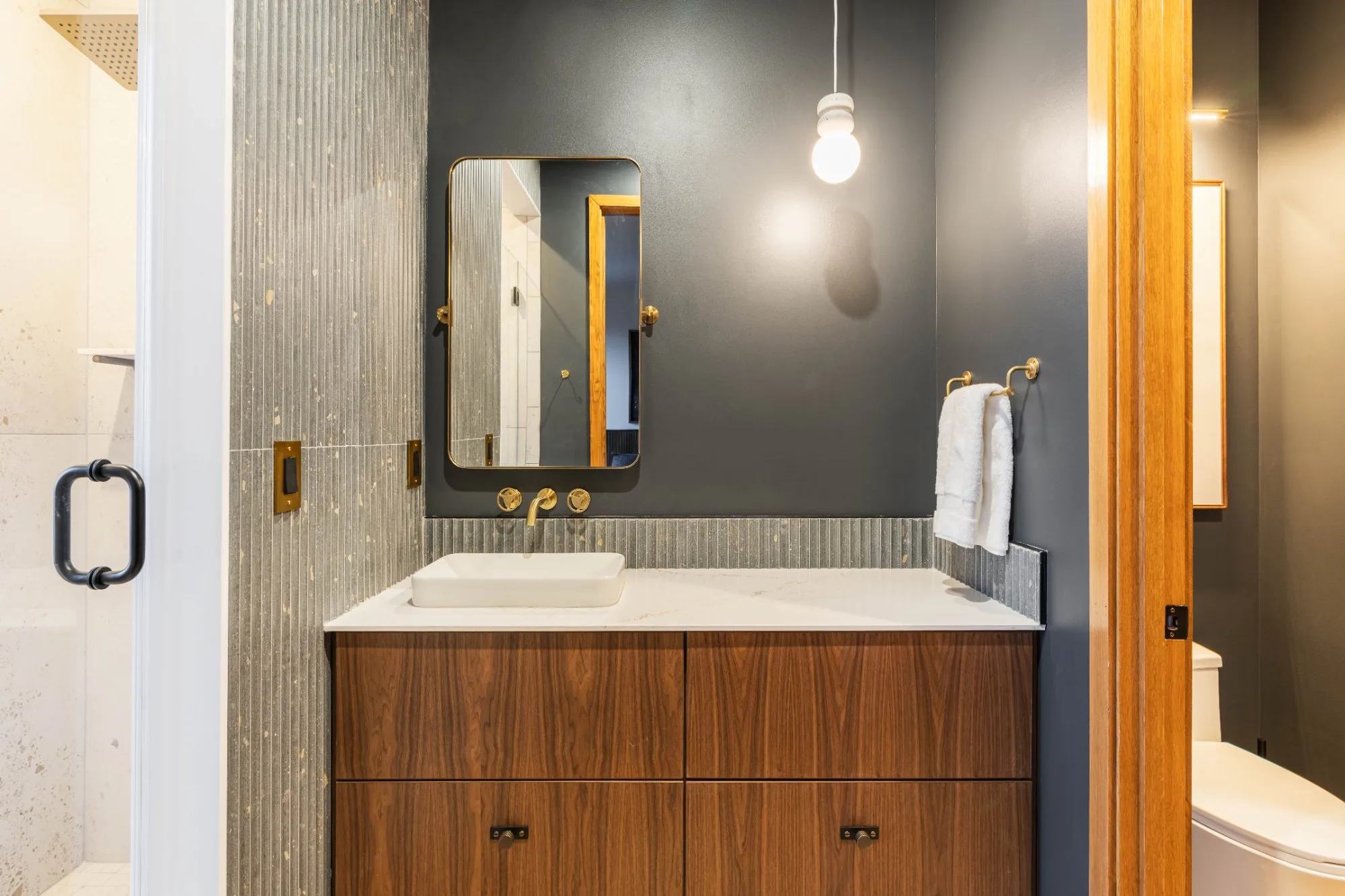 Second bathroom vanity with gold fixtures at Jackson Point