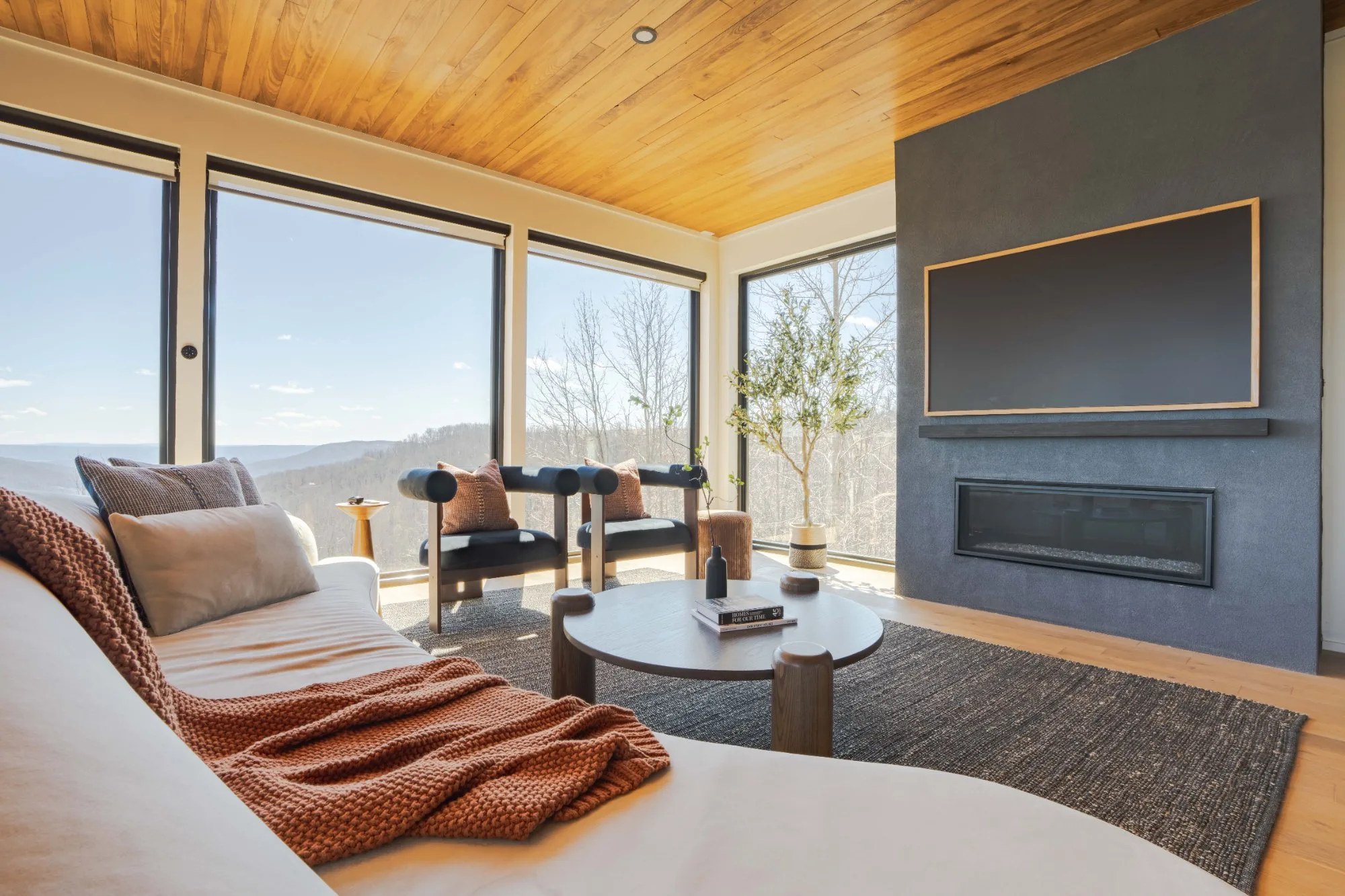 Gas fireplace and panoramic valley windows in living room at Jackson Point