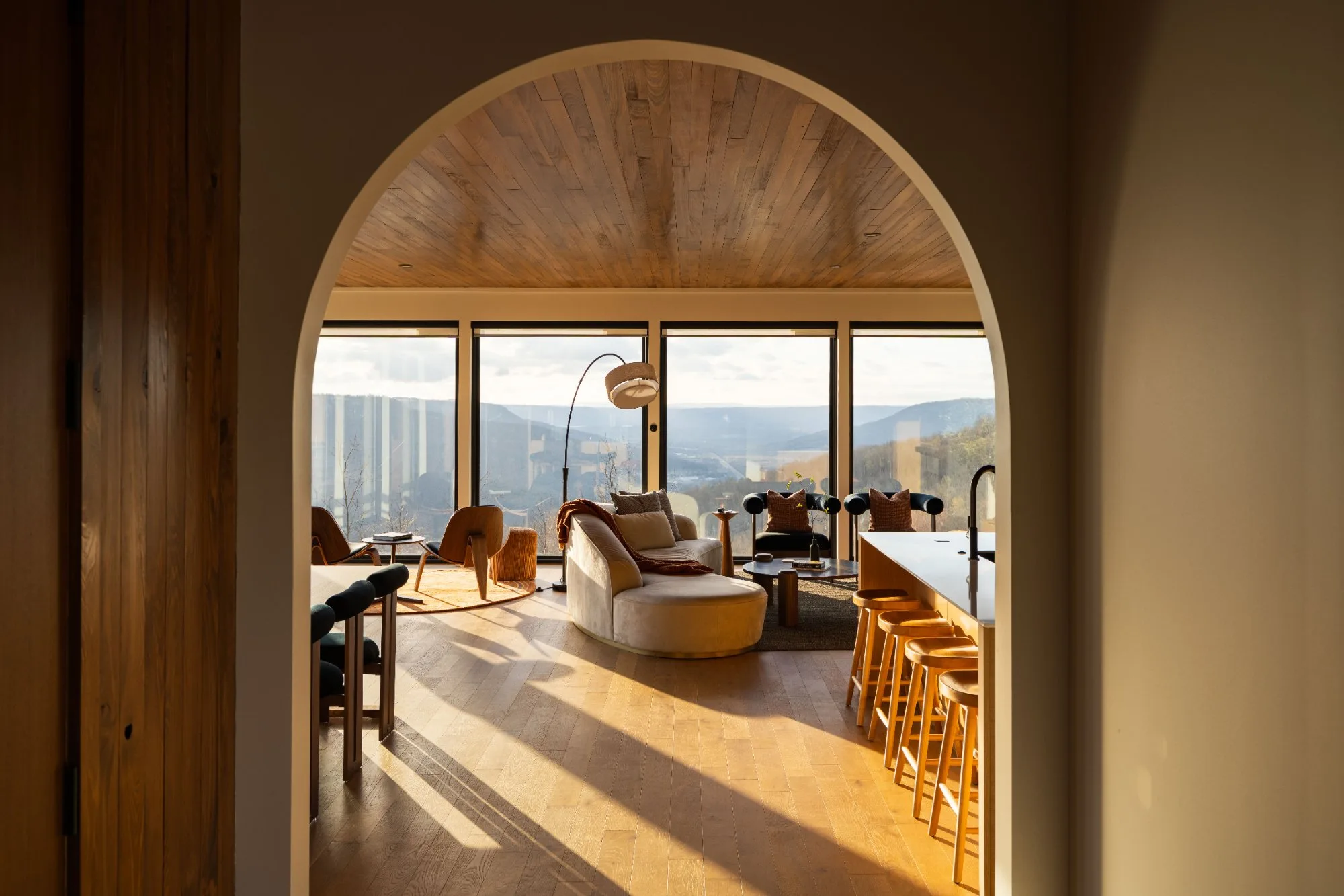 Arched entryway framing living room with valley view at Jackson Point Sewanee
